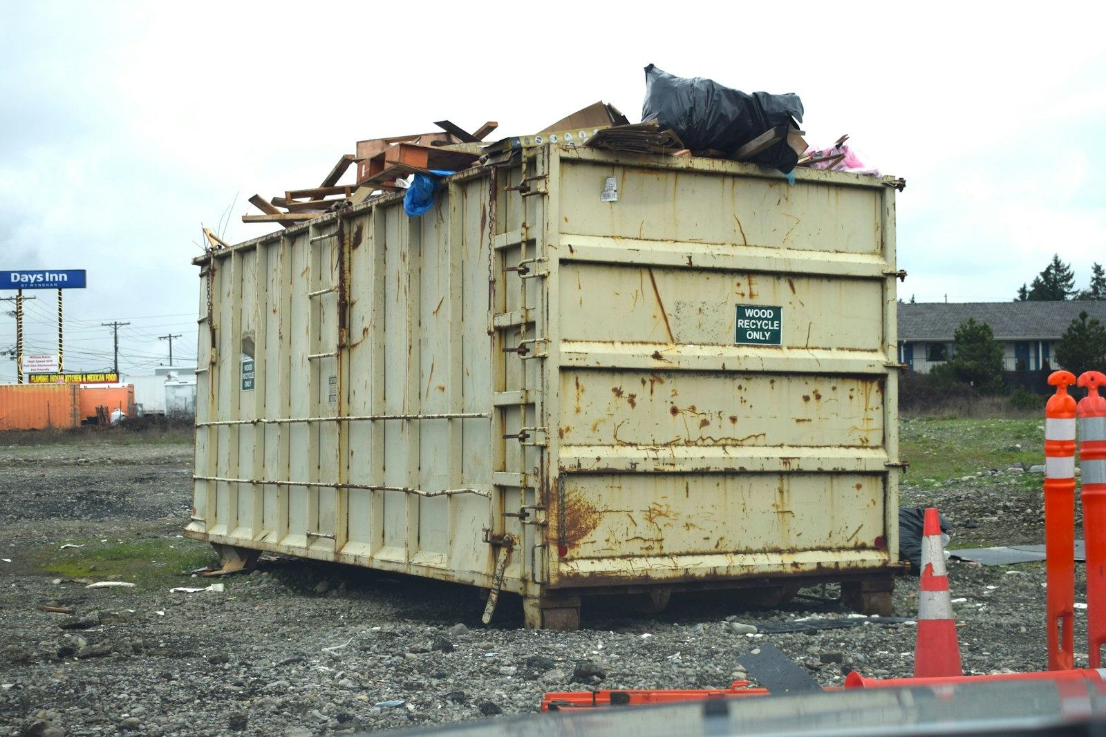 Loaded roll-off dumpster on a job site